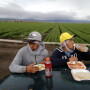 Mexican migrant farmworkers Jesus Martin Ley Lugo, 27, (R) and Rogelio Garcia Parria, 20, who both have H-2A visas, eat during a break while harvesting romaine lettuce in King City, California, U.S., April 17, 2017. REUTERS/Lucy Nicholson
