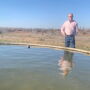 Terry Stands Next to Water Trough