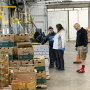 Holthouse Farms staff and others check out supplies for orders placed online with the company during the COVID-19 pandemic.