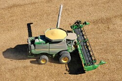 Run the reel on drapers farther forward and higher so the grain falls onto the belts causing less grain loss.