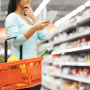 Woman grocery shopping with produce in basket