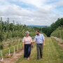 Brenda Briggs, vice president of sales and marketing for Rice Fruit Co., and Ben Rice, president, check on some of the company’s apple trees.