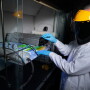Jacek Koziel adjusts infrared lamps and sensors in a Sukup Hall laboratory. Experiments on infrared light shows that it’s capable of mitigating the spread of the virus that causes porcine reproductive and respiratory syndrome. 
