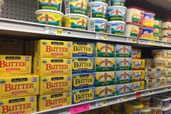 Butter on a shelf at a grocery store. 