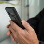 Person holding a cell phone by National Pork Board