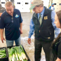 Fresh Wave purchasing director Ralph Donato, New Jersey Agriculture Secretary Doug Fisher and Consalo Family Farms produce operations vice president Chelsea Consalo inspect leeks at a 2019 season launch celebration.