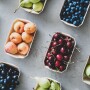 Cherries, blueberries, figs and other fruit separated in containers