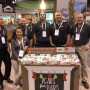 Rainier Fruit had a big presence at the Produce Marketing Association's Fresh Summit expo. Randy Abhold, president of Rainier Fruit, Selah, Wash., (far right), said there are plenty of strong apple promotion opportunities, starting now.