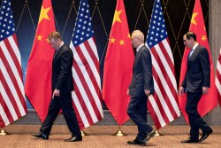 FILE PHOTO: U.S. Trade Representative Robert Lighthizer points at markers on the floor as he leads Chinese Vice Premier Liu He and Treasury Secretary Steven Mnuchin to their position for a family photo at the Xijiao Conference Center in Shanghai, China, July 31, 2019. Ng Han Guan/Pool via REUTERS/File Photo