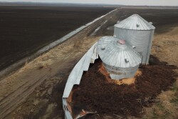 Busted grain bins still sit outside of White Cloud, Kansas. The rotting grain is a reminder of how devastating the flood of 2019 still is for farmers, landowners and residents. 
