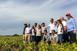 Pictured center, in sunglasses, Chris Adams hosts a delegation from Columbia. “It’s a two-way street. Foreign buyers want a face to trust,” he says.