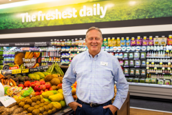 steve williams stands in produce department of a grocery store
