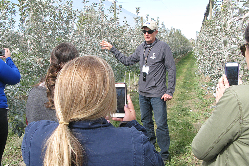 Neal Carter, founder and president of Okanagan Specialty Fruit, leads a tour at an orchard of Arctic apples last October. The company invited produce industry media, bloggers and food writers to explain how the genetically engineered apples were developed, and to talk about plans for increased production.
