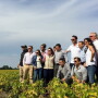 Pictured center, in sunglasses, Chris Adams hosts a delegation from Columbia. “It’s a two-way street. Foreign buyers want a face to trust,” he says.