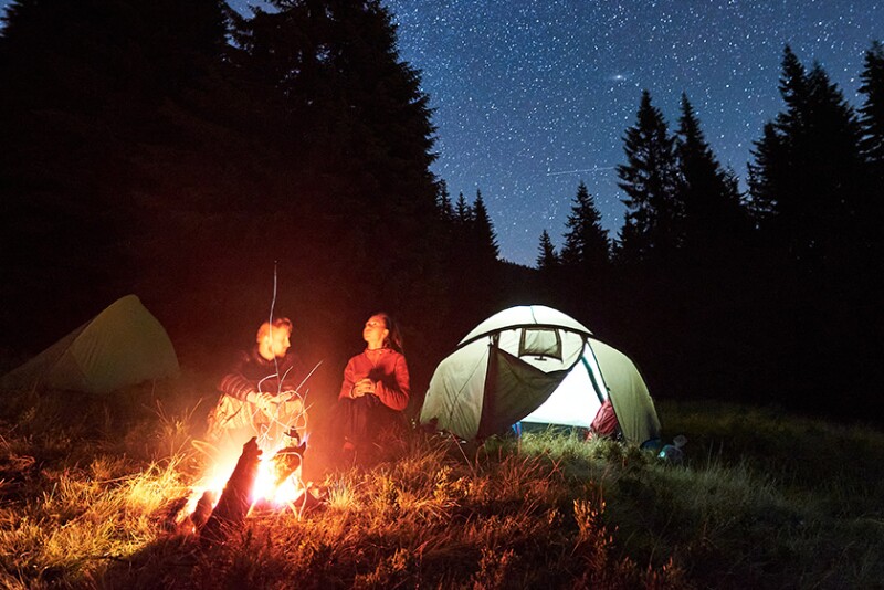 Two people at a campfire