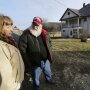 Julie and Phil Henneman, who lost their son Keith to suicide in 2006, when he was 29, talk about the experience outside the old farmhouse in Boscobel, Wis. The Hennemans continue to live on the 215-acre farm with two other sons, but they aren't farming. 
