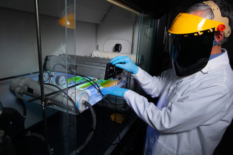 Jacek Koziel adjusts infrared lamps and sensors in a Sukup Hall laboratory. Experiments on infrared light shows that it’s capable of mitigating the spread of the virus that causes porcine reproductive and respiratory syndrome. 
