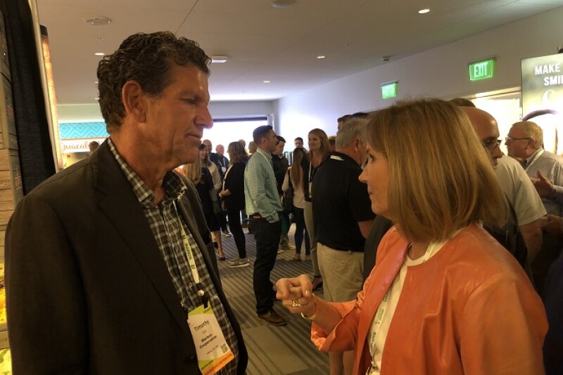 Tim York,  president of Markon Cooperative visits with Julie Krivanek,  president of Krivanek Consulting, Denver, Colo. on July 27 at Produce Marketing Association's Foodservice Conference and Expo in Monterey.
