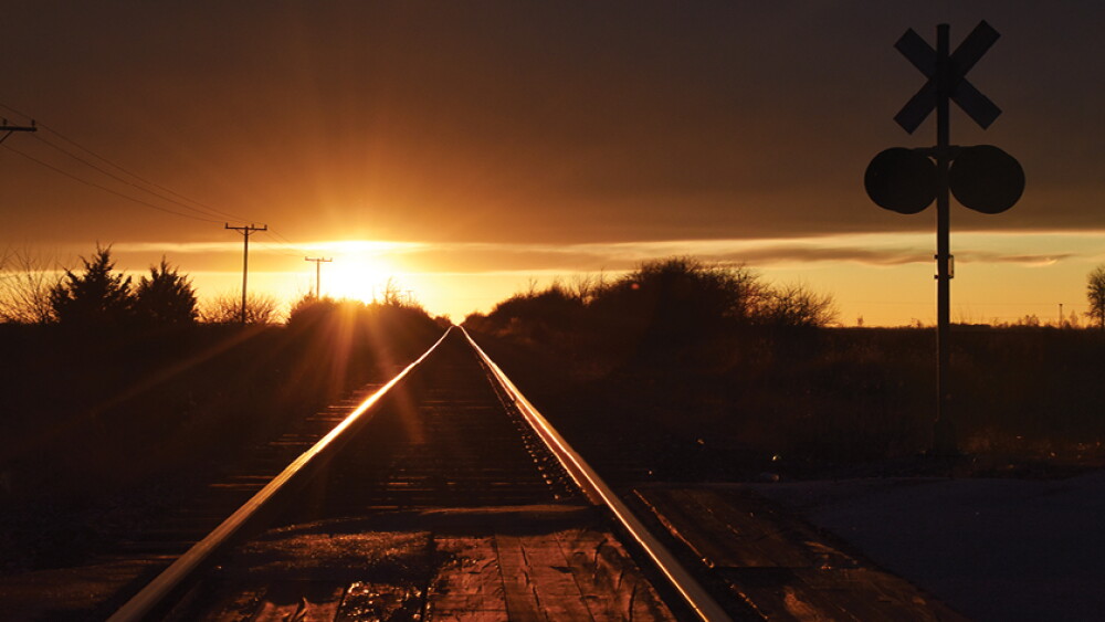 railroad train tracks sunset by Lindsey Pound