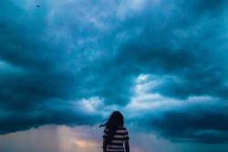 woman looking at stormy sky unsplash shashank sahay
