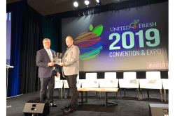  The Packer's editor-in-chief Tom Karst presents the 2019 Packer Man of the Year award to Grimmway president Jeff Huckaby. 