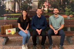 L.G. Herndon Jr. Farms and Gary Sinise Foundation representatives sit on the bench featured in the movie, “Forrest Gump.” 