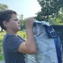 Farm Kid with feed bag on farm looking stressed