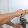 Biosecurity -man opening door to barn 