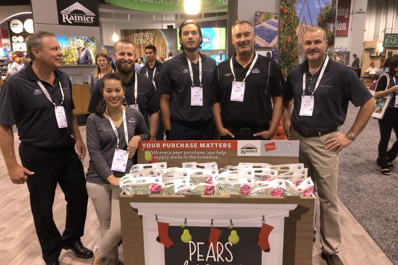 Rainier Fruit had a big presence at the Produce Marketing Association's Fresh Summit expo. Randy Abhold, president of Rainier Fruit, Selah, Wash., (far right), said there are plenty of strong apple promotion opportunities, starting now.