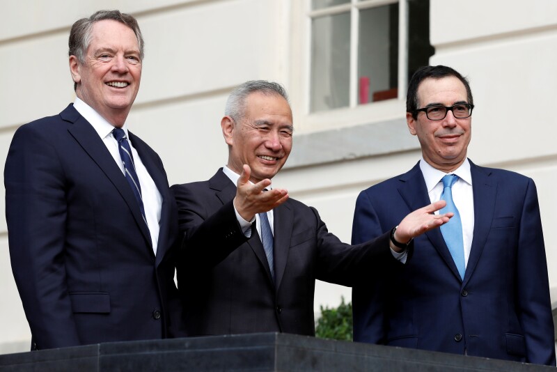 China's Vice Premier Liu He gestures to the media between U.S. Trade Representative Robert Lighthizer (L) and Treasury Secretary Steve Mnuchin before the two countries' trade negotiations in Washington, U.S., October 10, 2019. REUTERS/Yuri Gripas