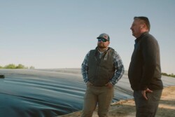 Wen Murphy and UC Davis Professor Frank Mitloehner next to anaerobic digester on a swine farm.