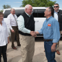 Agriculture Sonny Perdue (center) greets Robert Sakata of Sakata Farms in May in Brighton, Colo., during one of his numerous visits to fruit and vegetable operations.