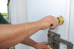 Biosecurity -man opening door to barn 