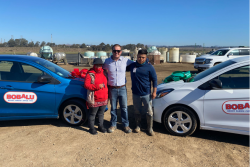 RC Jones (center), managing member of Bobalu Berry Farms, with workers Guillermo and Eva, who won cars at the company's end-of-season celebration for strawberries.