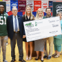 On hand for a $20,000 check presentation to Ocean Township Intermediate School were Jets Flight Crew member Jenna (from left), Jets linebacker Brandon Copeland, New Jersey Secretary of Agriculture Douglas Fisher, Jets community relations assistant Maddy Brown, Ocean Township Schools Sodexo foodservice manager Jackie Wagner, physical education teacher John Dellapesca, NJDA school nutrition programs marketing specialist Jackie Bricker, school principal Larry Kostula, and American Dairy North East marketing representative Aisha King.
