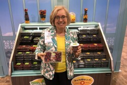 Janice Honigberg, president of Sun Belle,   Schiller Park, Ill. displays cranberries and pomegranate arils at the Produce Marketing Association's Fresh Summit expo.