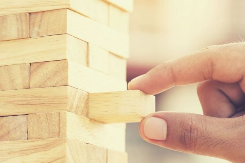 Man pulling block out of Jenga game