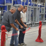 Scott Halliday (from left), Diamond Fruit Growers chairman, David Garcia, Diamond president, and Angelo Benedetti, CEO of Unitec, cut the ribbon July 16 at the unveiling of a special pear packing line at the Diamond Fruit packing facility in Hood River, Ore.