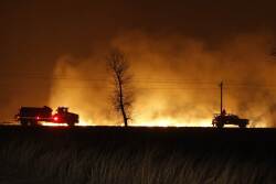 Firefighters from across Kansas and Oklahoma battle a wildfire near Protection, Kan., Monday, March 6, 2017.