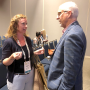 At another conference, Steve Lutz (right) speaks with an attendee after a session.